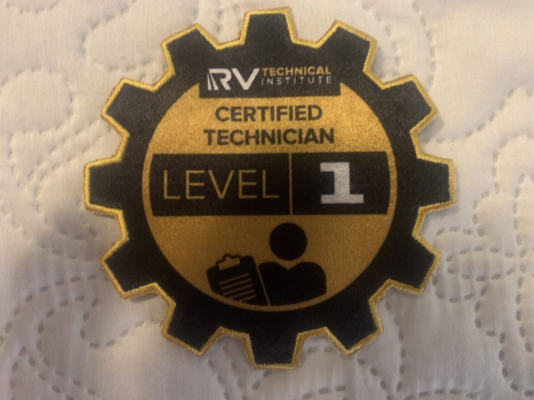 A badge that says level 1 certified technician